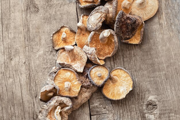 Dried shiitake mushrooms on a wooden background