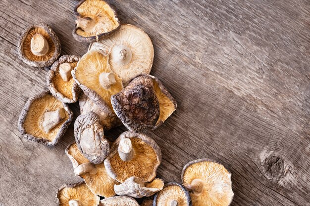 Dried shiitake mushrooms on a wooden background