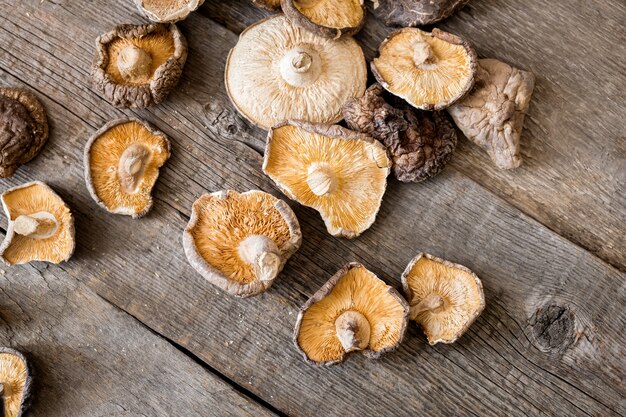 Dried shiitake mushrooms on a wooden background