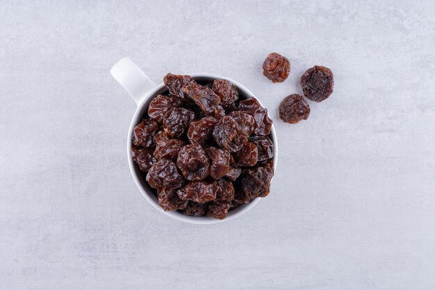 Dried sour black cherries in a cup. High quality photo