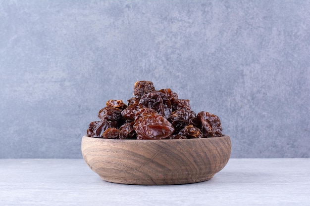 Dried sour cherries in a cup on concrete background. High quality photo