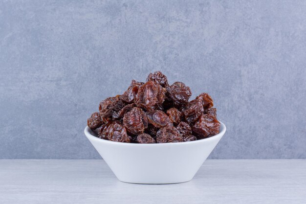 Dried sour cherries isolated in a plate on the background. High quality photo