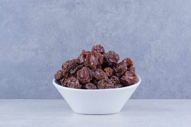 Dried sour cherries isolated in a plate on the background. High quality photo