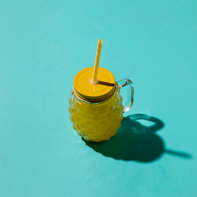 Drinking jar with lemonade on blue background