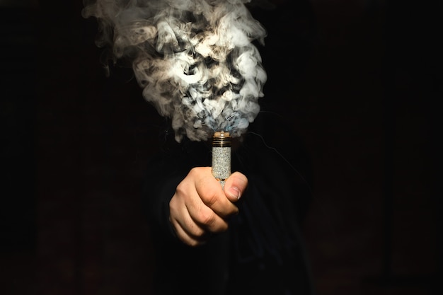 Free photo dripper in one hand making a cloud of fume