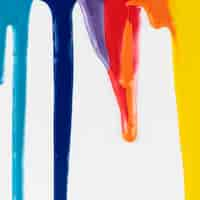 Free photo dripping colorful paints on white background