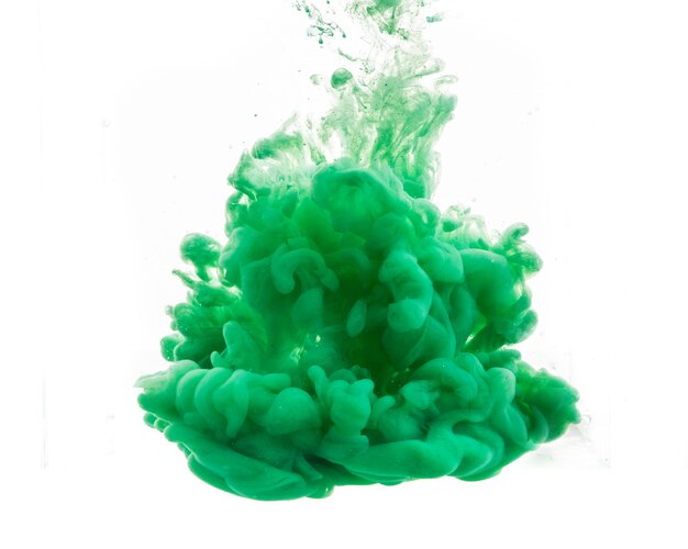 Drop of green paint falling in water