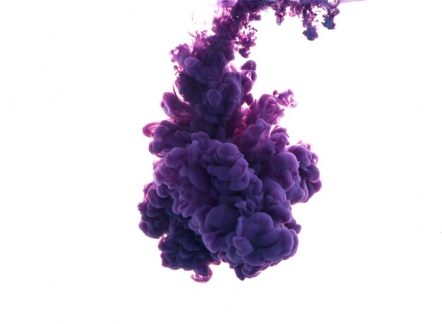 Drop of purple paint falling on water