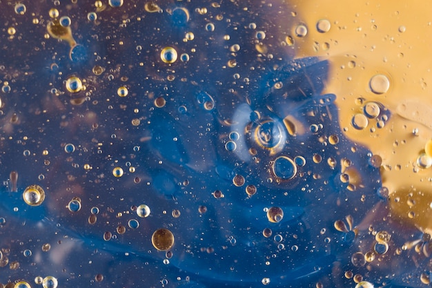 Drops of oil on blue background