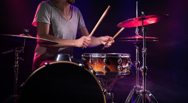 The drummer plays the drums