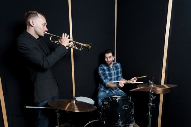 Drummer and trumpet player performing