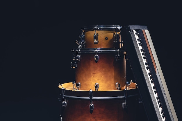 Drums and musical keys on a black background isolated