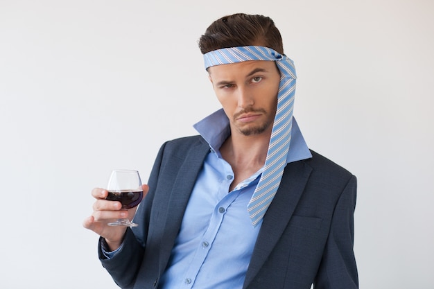 Free photo drunk business man with tie on head and glass