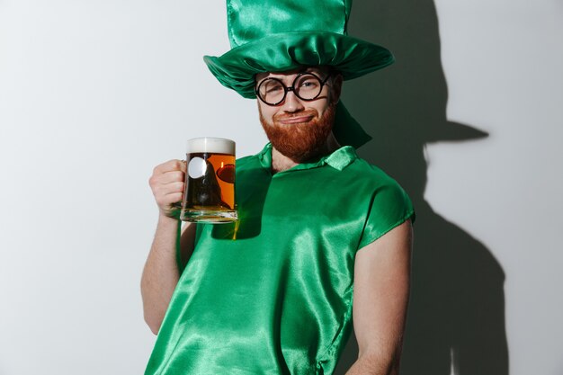 Drunk man in st.patriks costume holding beer