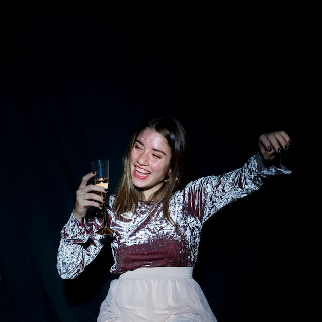 Drunk woman in dress with champagne glass