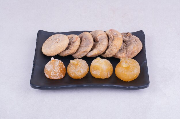 Dry figs and cherries on a ceramic platter