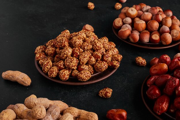 Dry fruits and candies in saucers. 