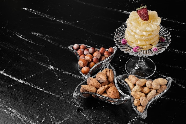 Free photo dry fruits and pineapple slices in glass dishes.