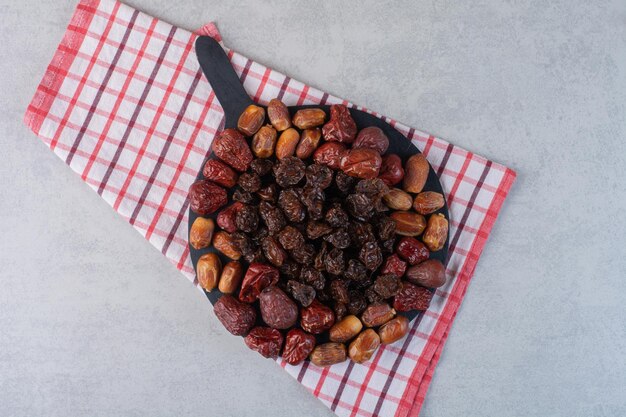 Free photo dry fruits platter isolated on concrete surface.