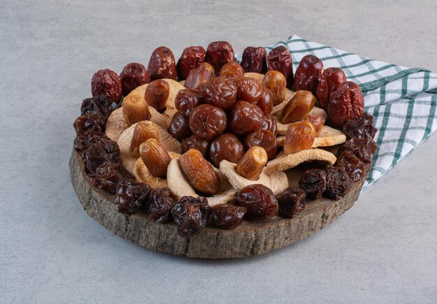Dry fruits platter isolated on concrete surface.