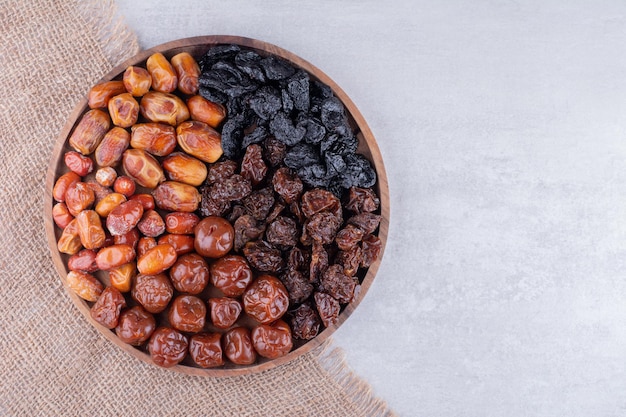 Free photo dry fruits set with dates and cherries on a wooden platter. high quality photo