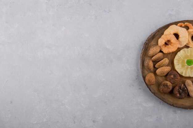 Dry fruits and snacks in wooden platter