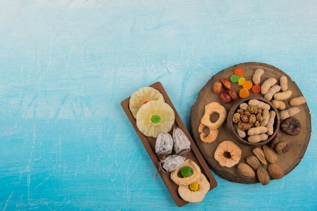 Dry fruits and snacks in wooden platters