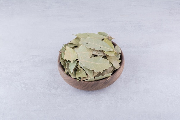 Dry green bay leaves in a rustic cup. High quality photo