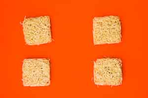 Free photo dry instant noodles arranged on plain bright orange surface