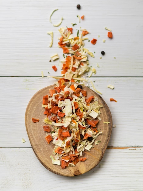 Dry leaves and spices on round wooden tray