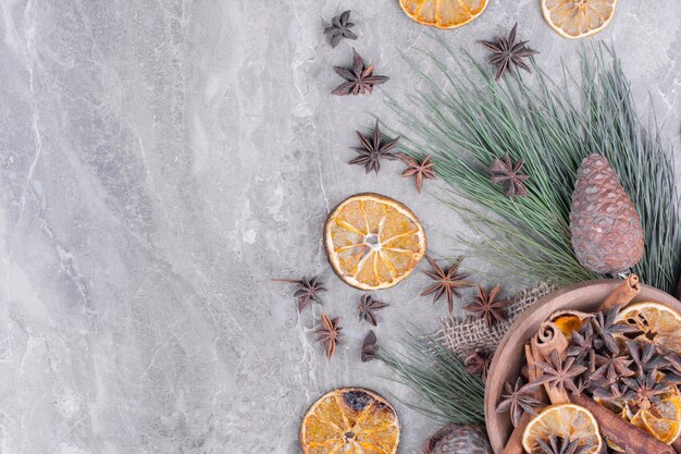 Dry orange slices with anise in a wooden cup.