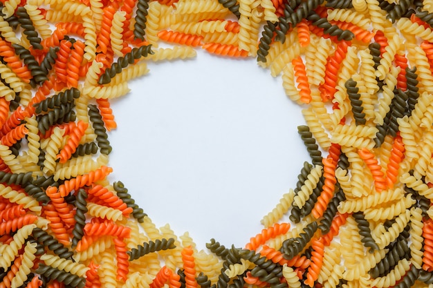 Dry pasta pile flat lay on a white table