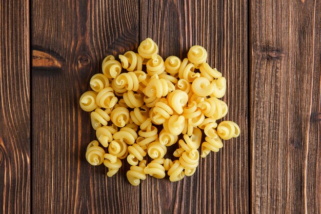 Dry pasta pile flat lay on a wooden table