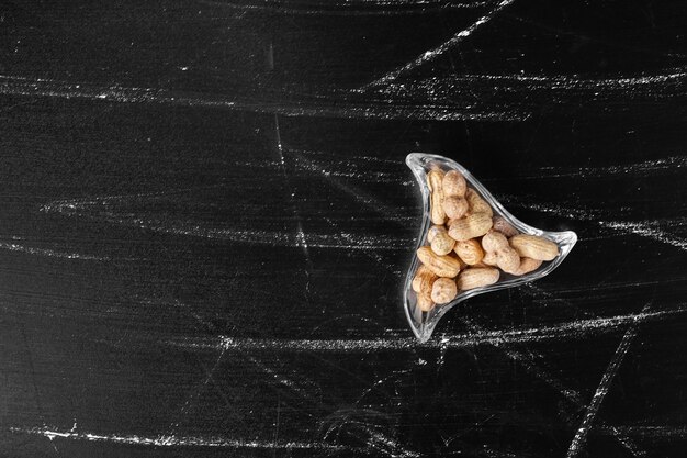 Dry peanuts in glass cups, top view. 