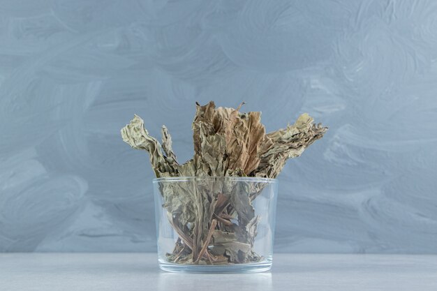 Dry tea leaves in glass  