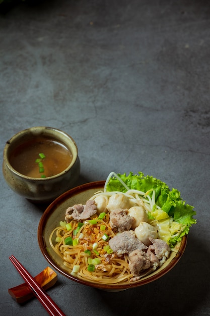 Dry thin noodles with stewed pork and pork ball.