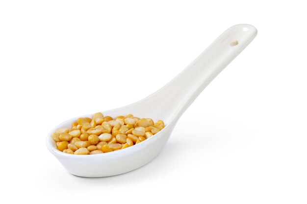 Dry yellow split peas isolated on white