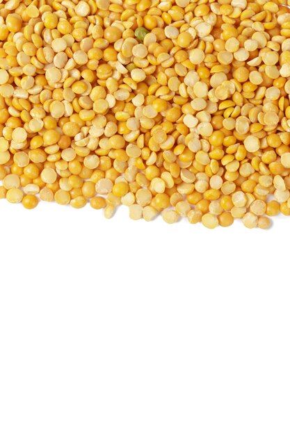 Dry yellow split peas isolated on white.