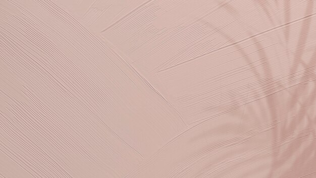 Dull pink paint texture background with leaf shadow