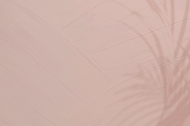 Dull pink paint texture background with leaf shadow