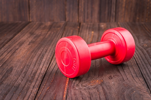 dumbbell on wood background