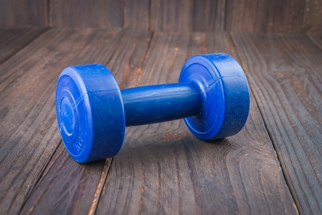 Dumbbell on wood background