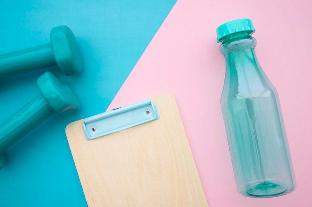 Dumbbells, bottle and clipboard