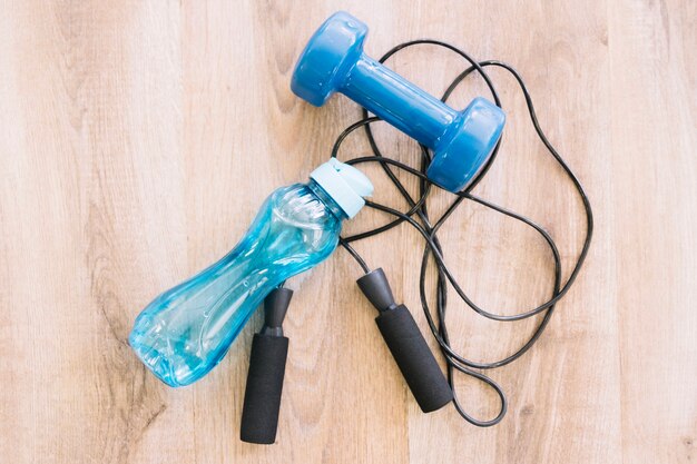 Dumbell, jump rope and bottle of water