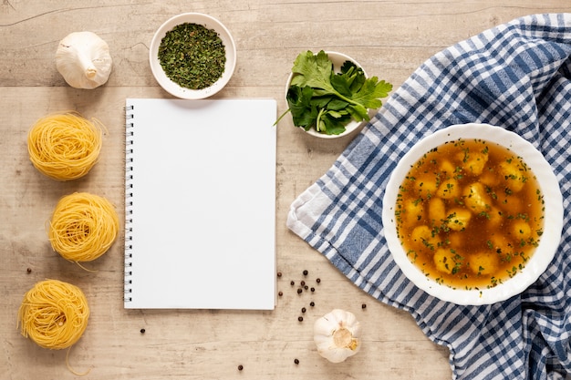 Free photo dumpling soup with pasta and notepad