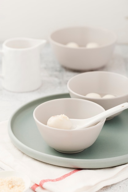 Dumplings in bowl with spoon and plate