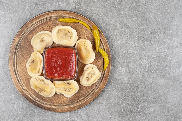 Dumplings filled with meat on wooden board