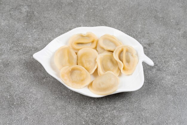 Dumplings stuffed with meat on white plate