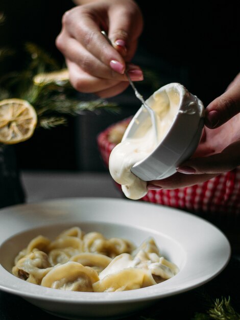 Dumplings toppped with sour cream