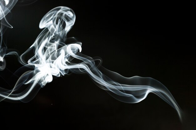 Dynamic smoke silhouette on black background